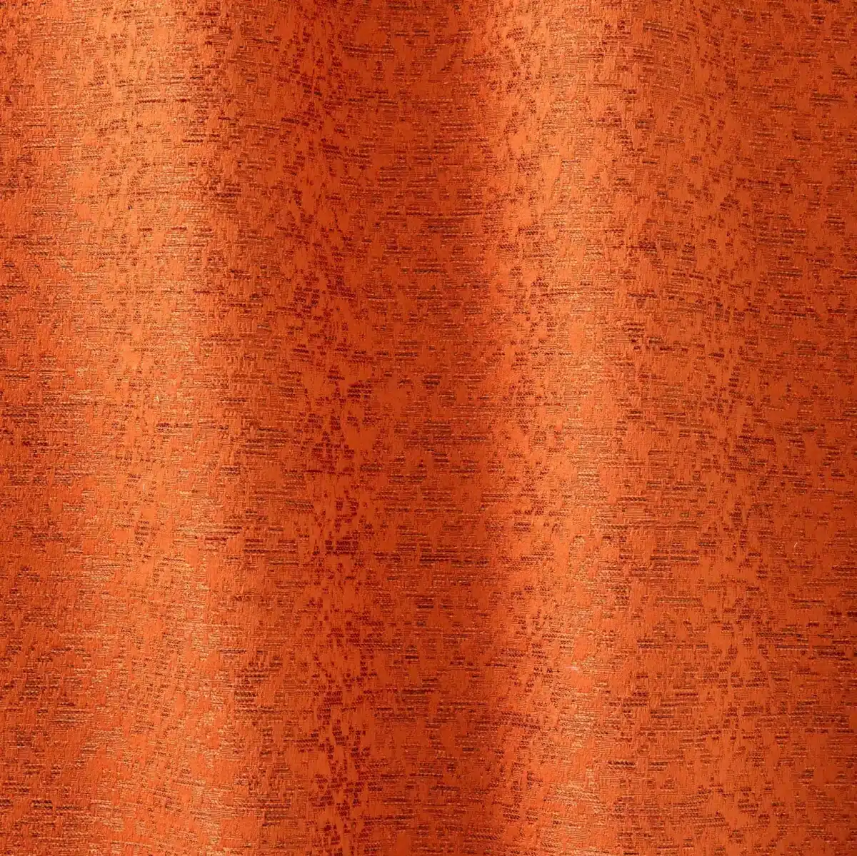 The image shows a close-up of a textured orange curtain with intricate patterns, softly lit by natural light.