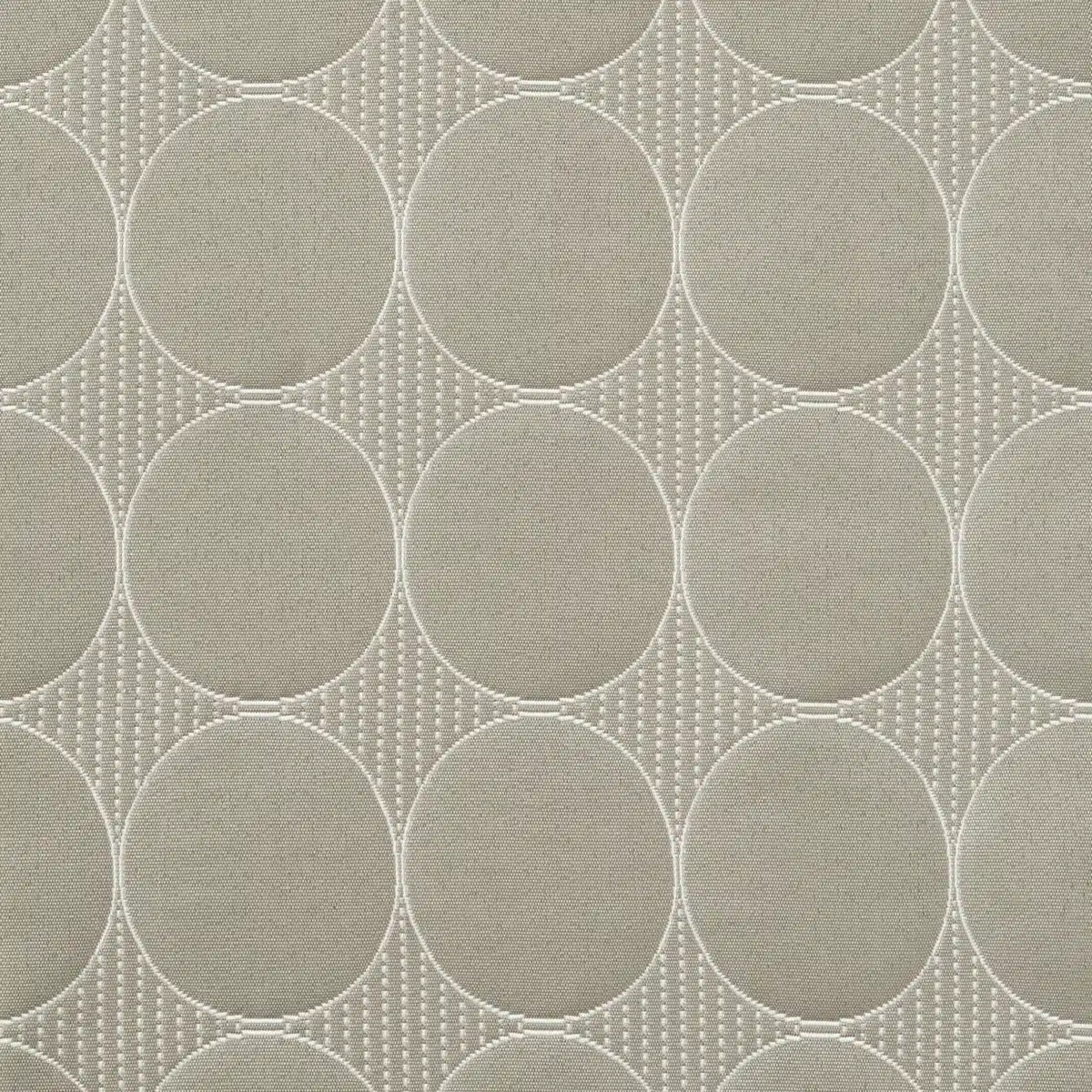 Patterned fabric featuring repeating large circles and intricate lines, creating a geometric design in shades of beige and light brown.