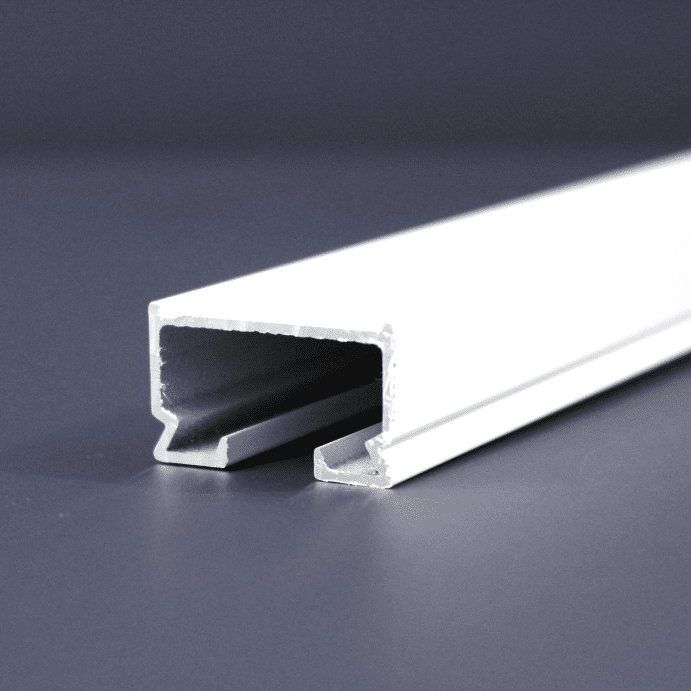 A close-up image of a white, aluminum U-channel on a grey surface, with its hollow interior and smooth edges visible.